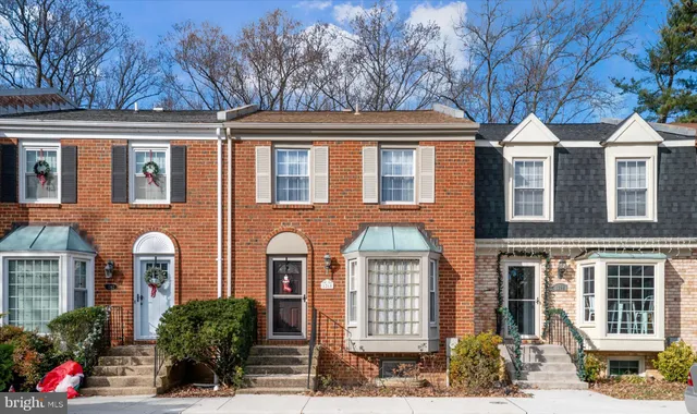 a front view of a residential houses with yard