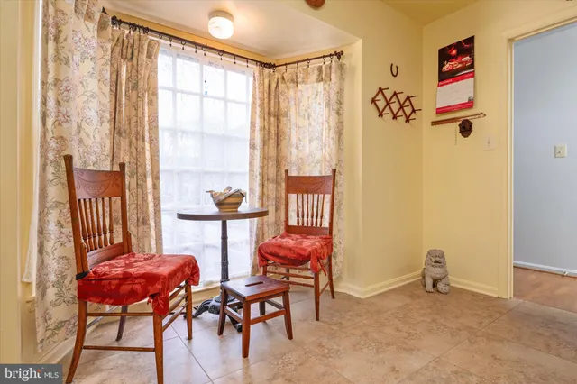 a view of a livingroom with furniture and a window