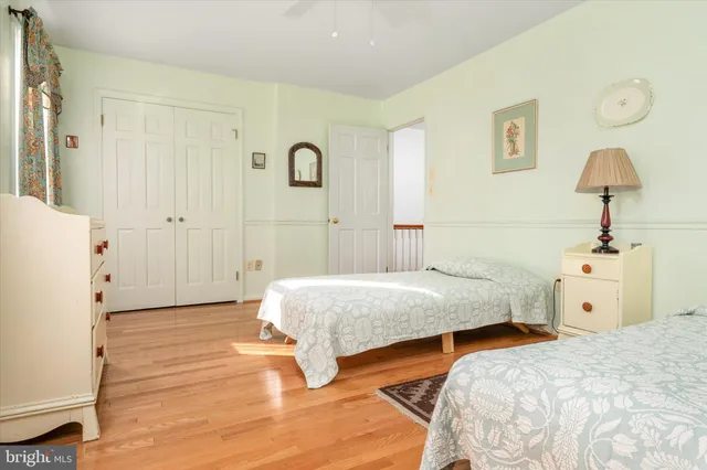 a bedroom with two bed and a window