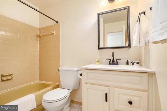 a bathroom with a sink vanity mirror and toilet