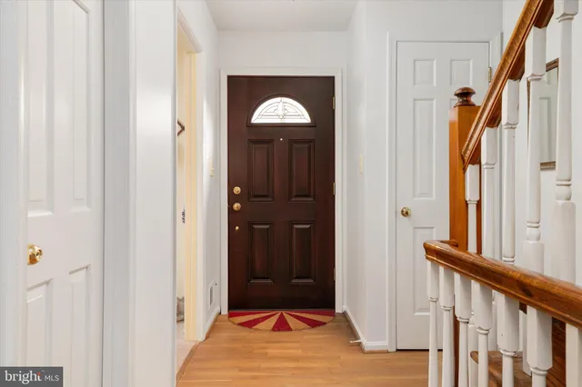 a view of a hallway with wooden floor and entryway