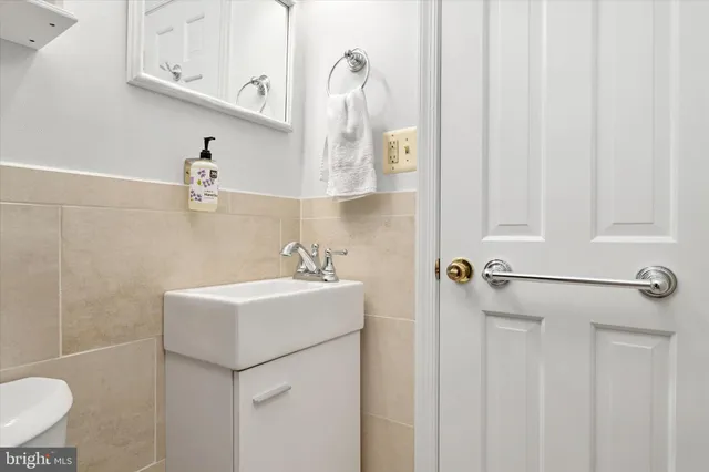 a bathroom with a sink a toilet and mirror