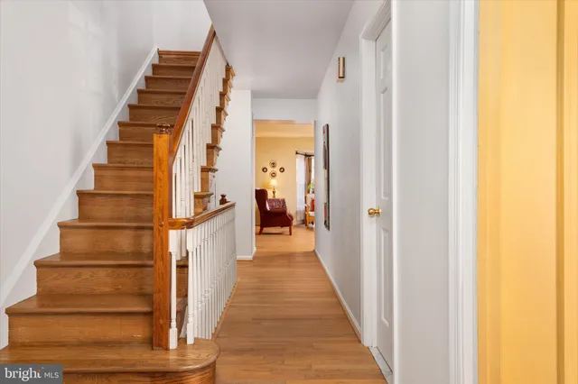 a view of a hallway with wooden floor and entryway