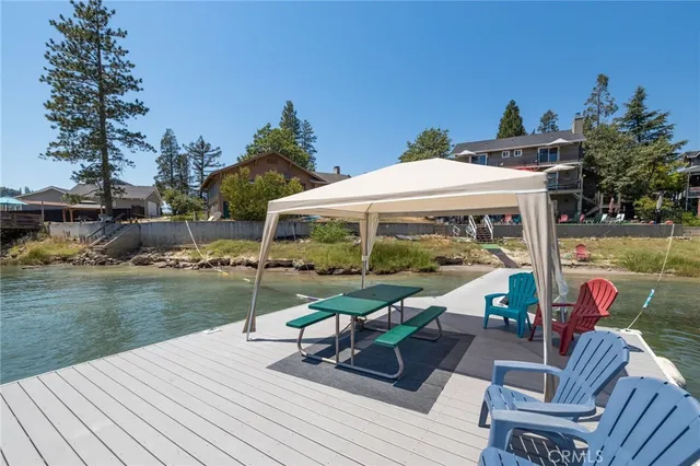 a view of a cafe with a table and chairs under an umbrella