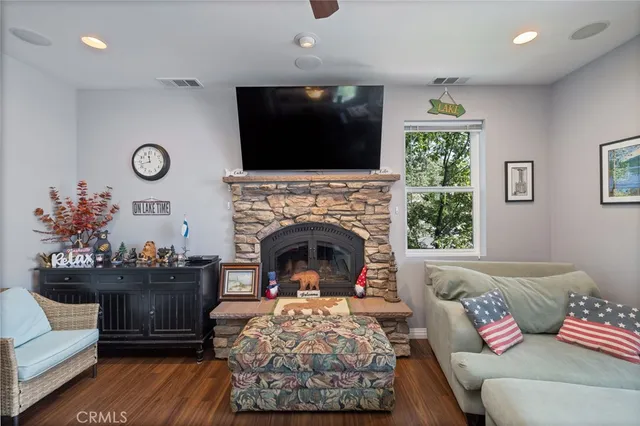 a kitchen with granite countertop a sink a stove cabinets and wooden floor