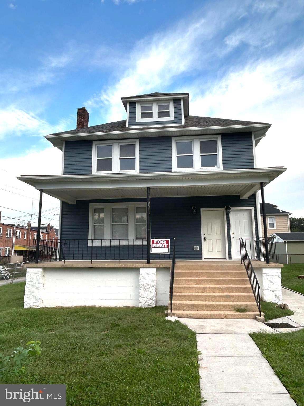 3902 West Rogers Avenue, Unit 1 Baltimore, MD 21215 - Photo 1 of 12 a front view of a house with a yard