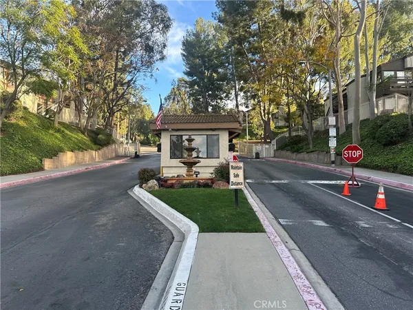 a view of patio with chairs and a table under an umbrella