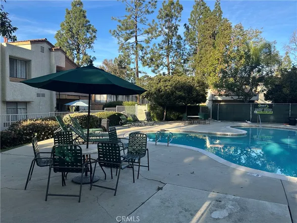 a view of fountain with tree in the background