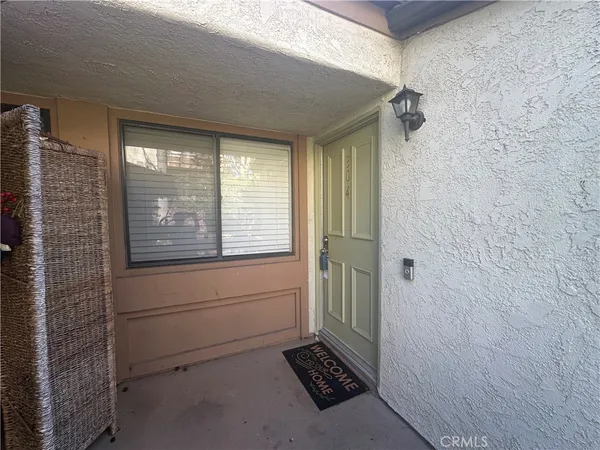 a view of a room with wooden floor and windows