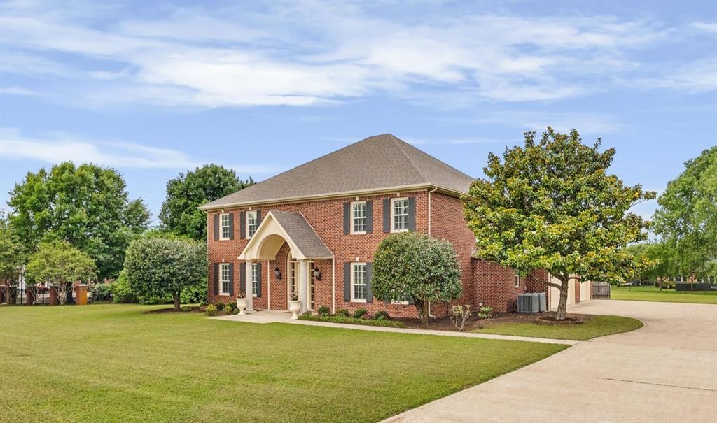 506 Meadowview Road Heath, TX 75032 - Photo 5 of 32 a front view of a house with a garden and yard