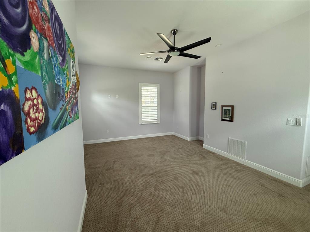 13110 Bamboo Street Spring Hill, FL 34609 - Photo 22 of 56 a view of a livingroom with a ceiling fan and window