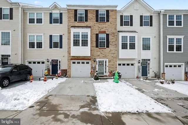 a view of a street that has couple of cars parked in front of it