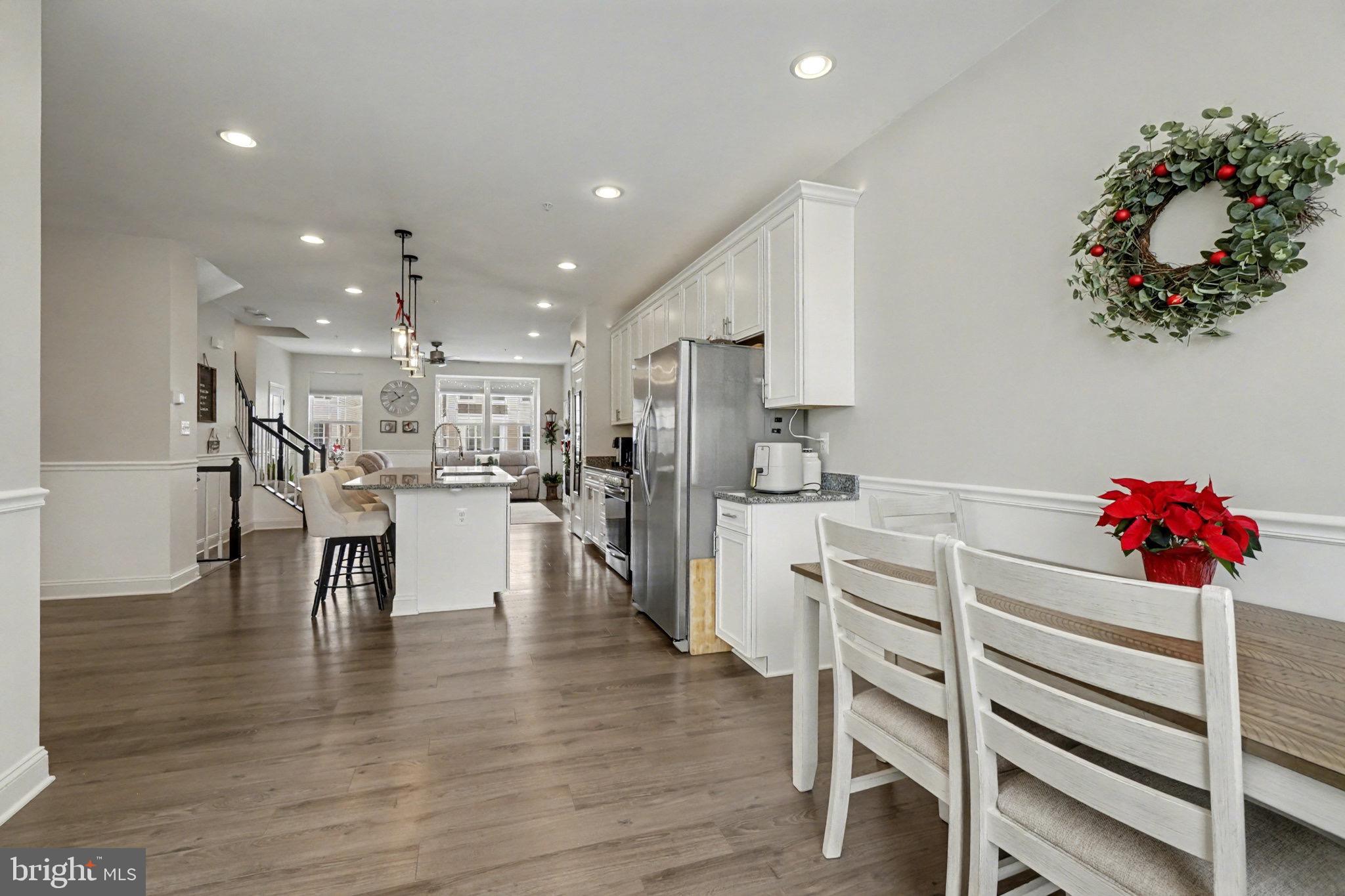 1225 Fenwick Road Aberdeen, MD 21001 - Photo 14 of 52 a kitchen with white cabinets and chandelier