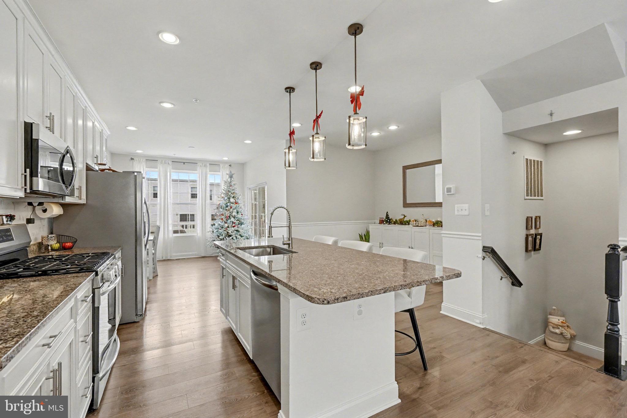 1225 Fenwick Road Aberdeen, MD 21001 - Photo 18 of 52 a kitchen with stainless steel appliances granite countertop a kitchen island hardwood floor sink stove and refrigerator