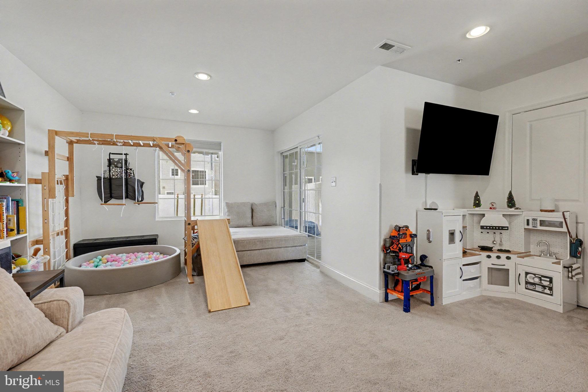 1225 Fenwick Road Aberdeen, MD 21001 - Photo 22 of 52 a view of a livingroom with furniture and a flat screen tv