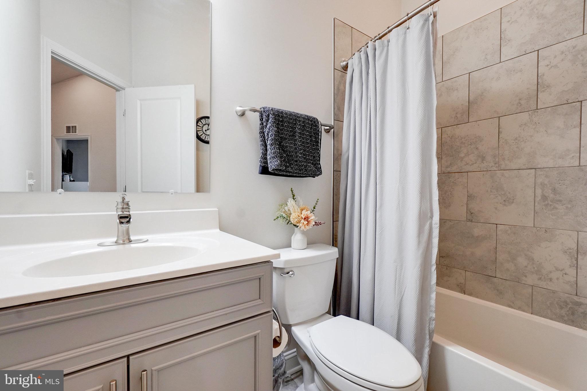 1225 Fenwick Road Aberdeen, MD 21001 - Photo 37 of 52 a bathroom with a sink a toilet a mirror and shower