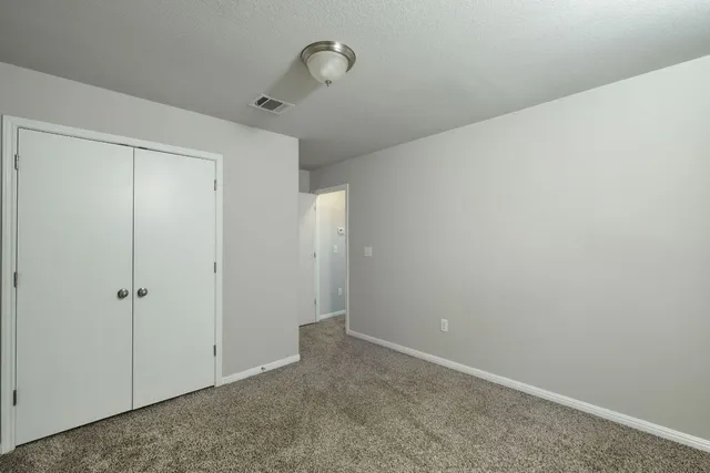 a bathroom with a bathtub shower sink vanity mirror and toilet