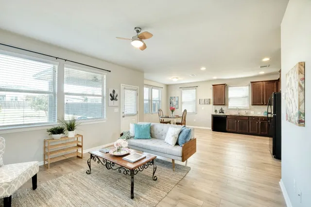 a living room with furniture and a potted plant