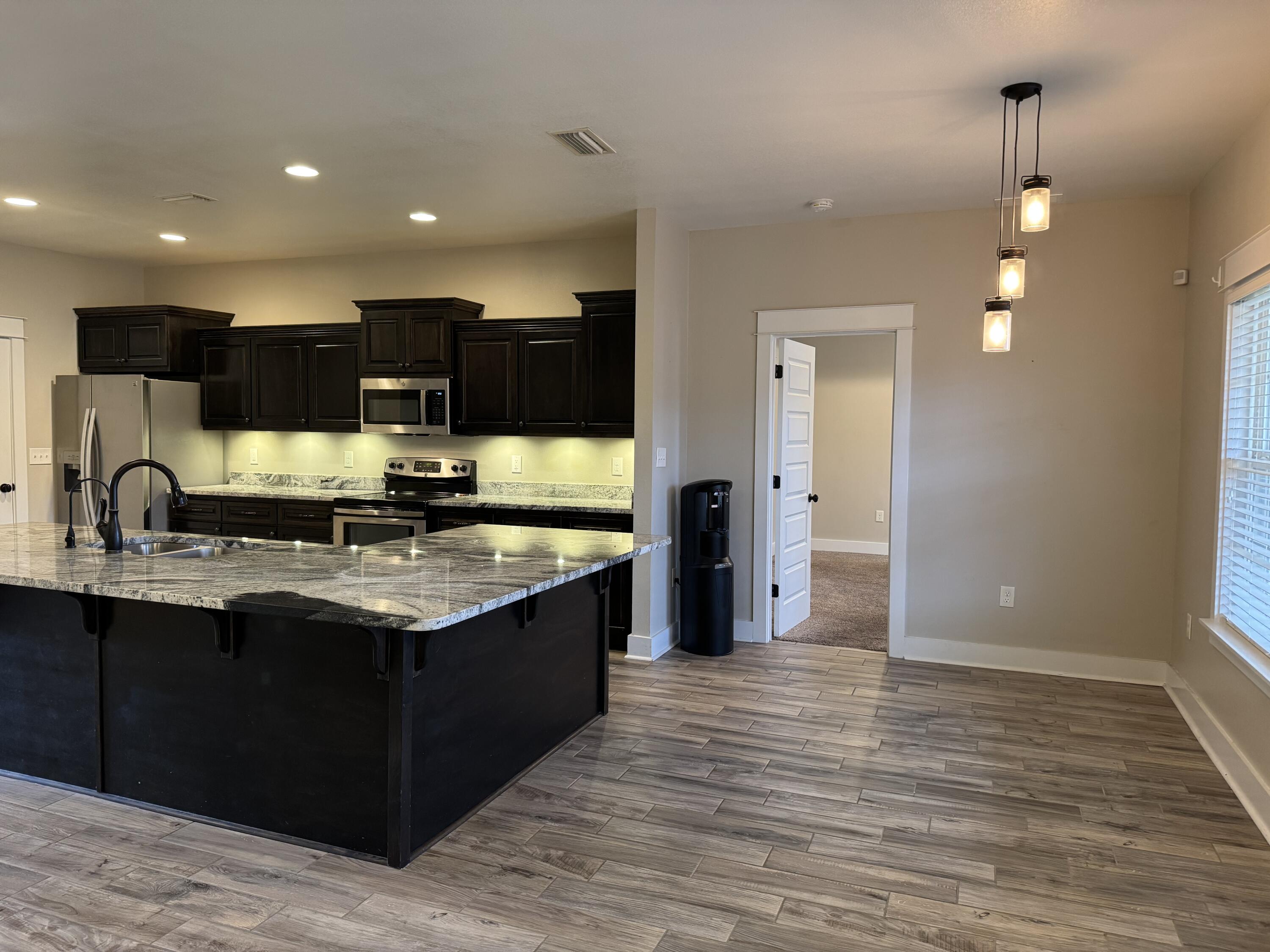 4075 Happy Trails Road Crestview, FL 32539 - Photo 4 of 11 a view of kitchen with stainless steel appliances granite countertop a sink and a stove