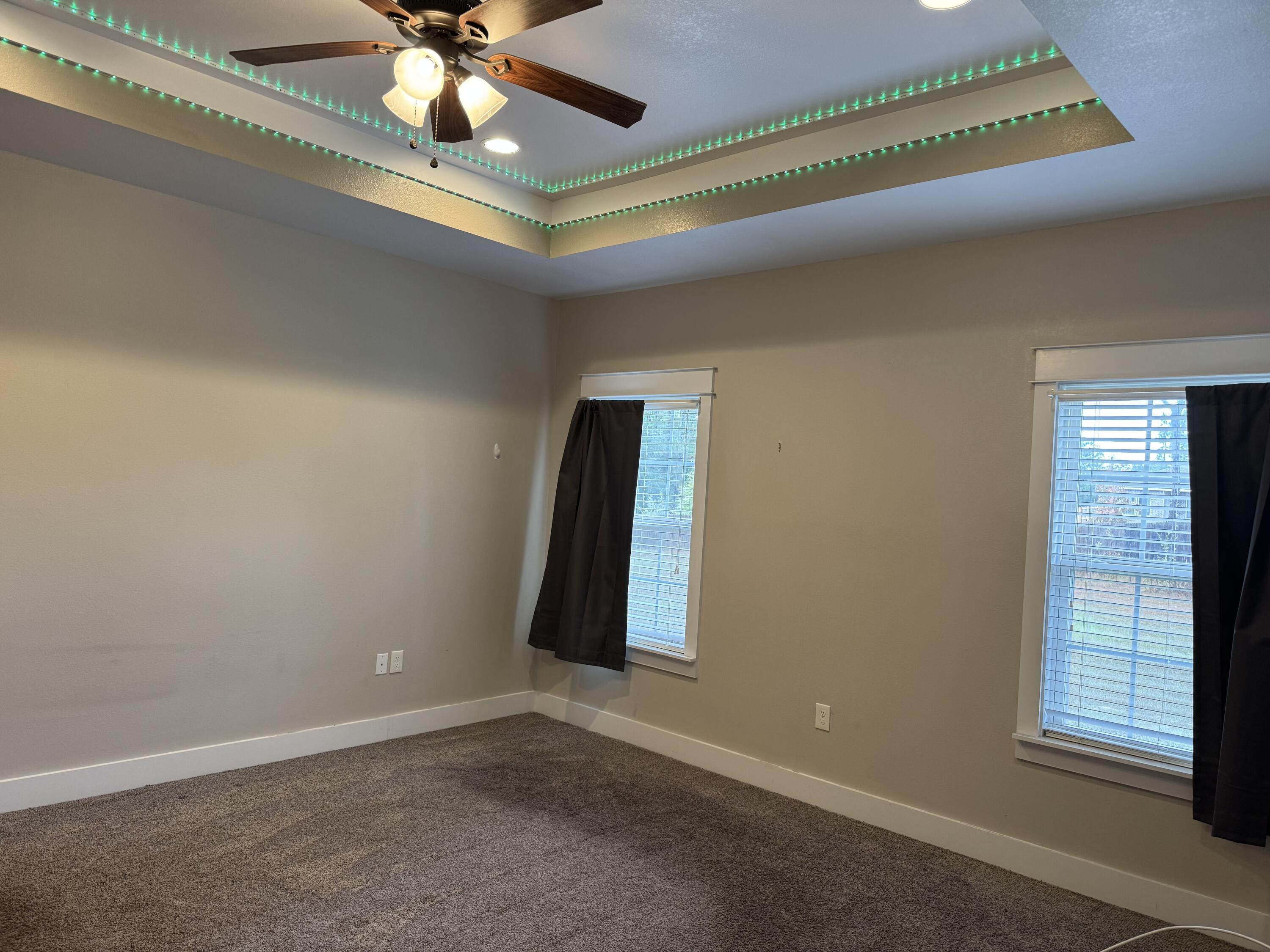 4075 Happy Trails Road Crestview, FL 32539 - Photo 6 of 11 an empty room with windows and fan