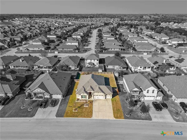 an aerial view of a house with a parking space