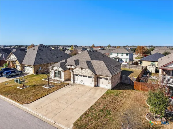 an aerial view of a house with a yard
