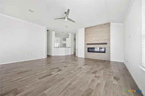 a view of empty room with a fireplace
