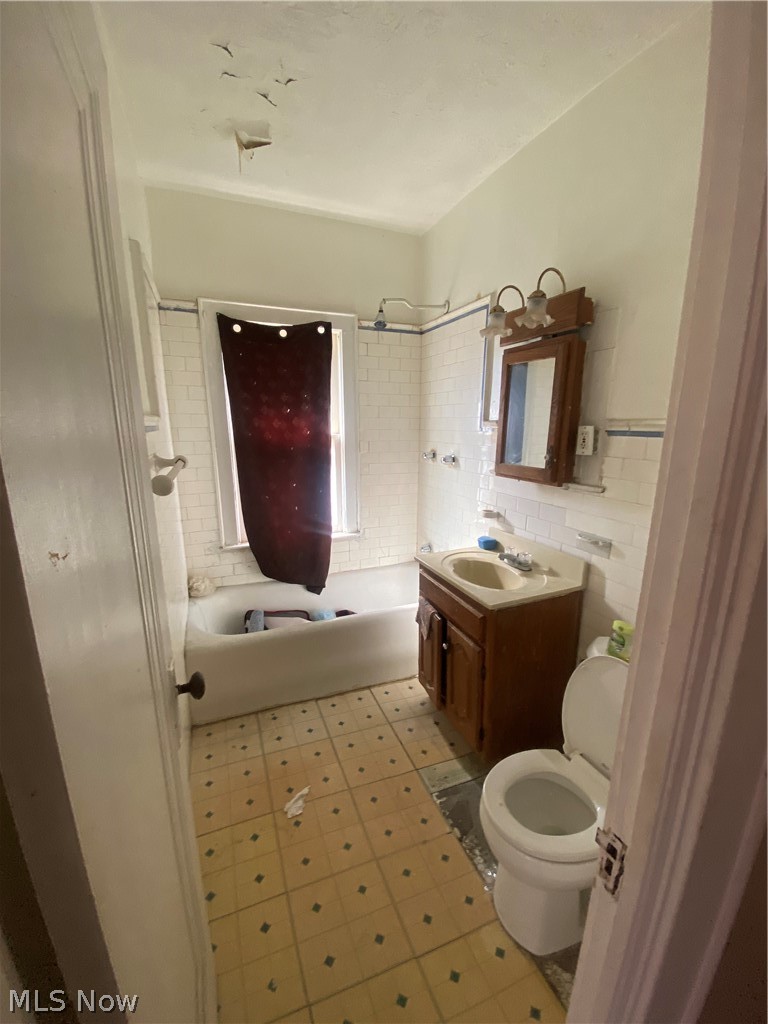 3634 Hildana Road Cleveland, OH 44120 - Photo 7 of 11 Upstairs Full bathroom featuring vanity, toilet, tile flooring, and tiled shower / bath