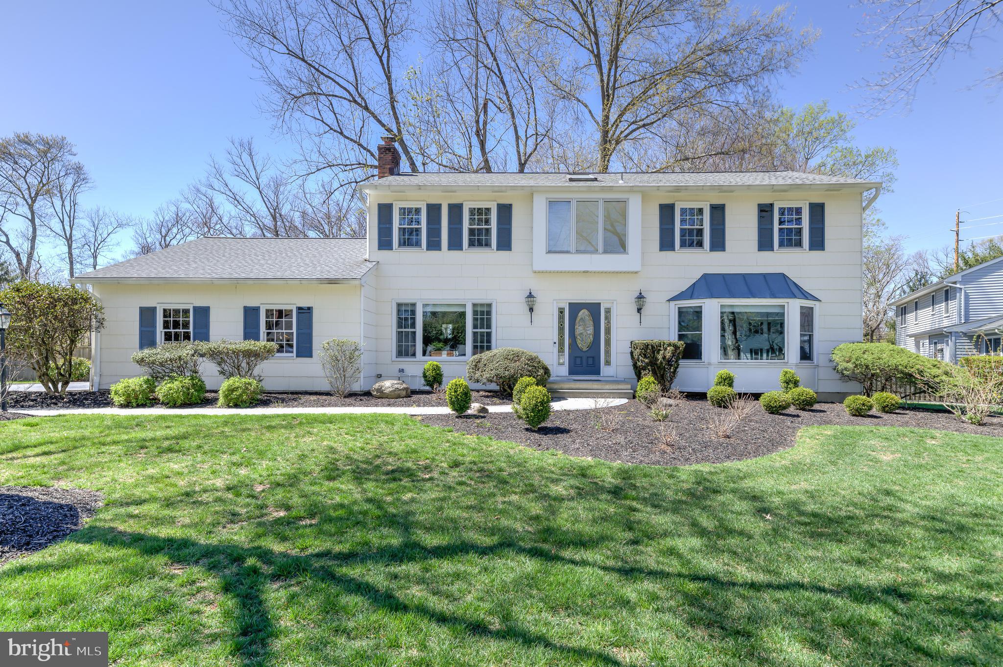 a front view of a house with garden and porch