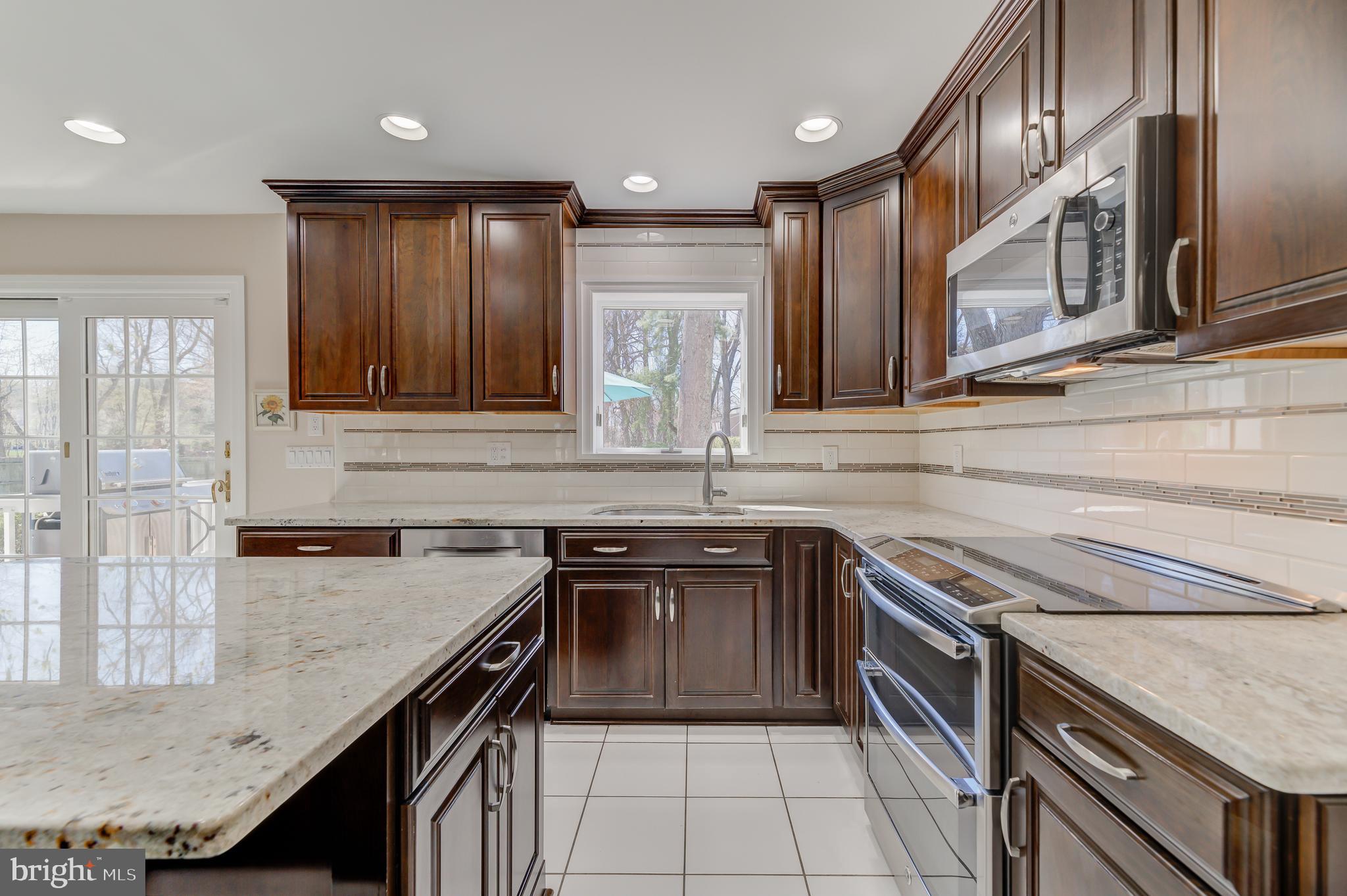 4 Hawk Drive Princeton Junction, NJ 08550 - Photo 11 of 45 a kitchen with stainless steel appliances granite countertop a sink stove and cabinets