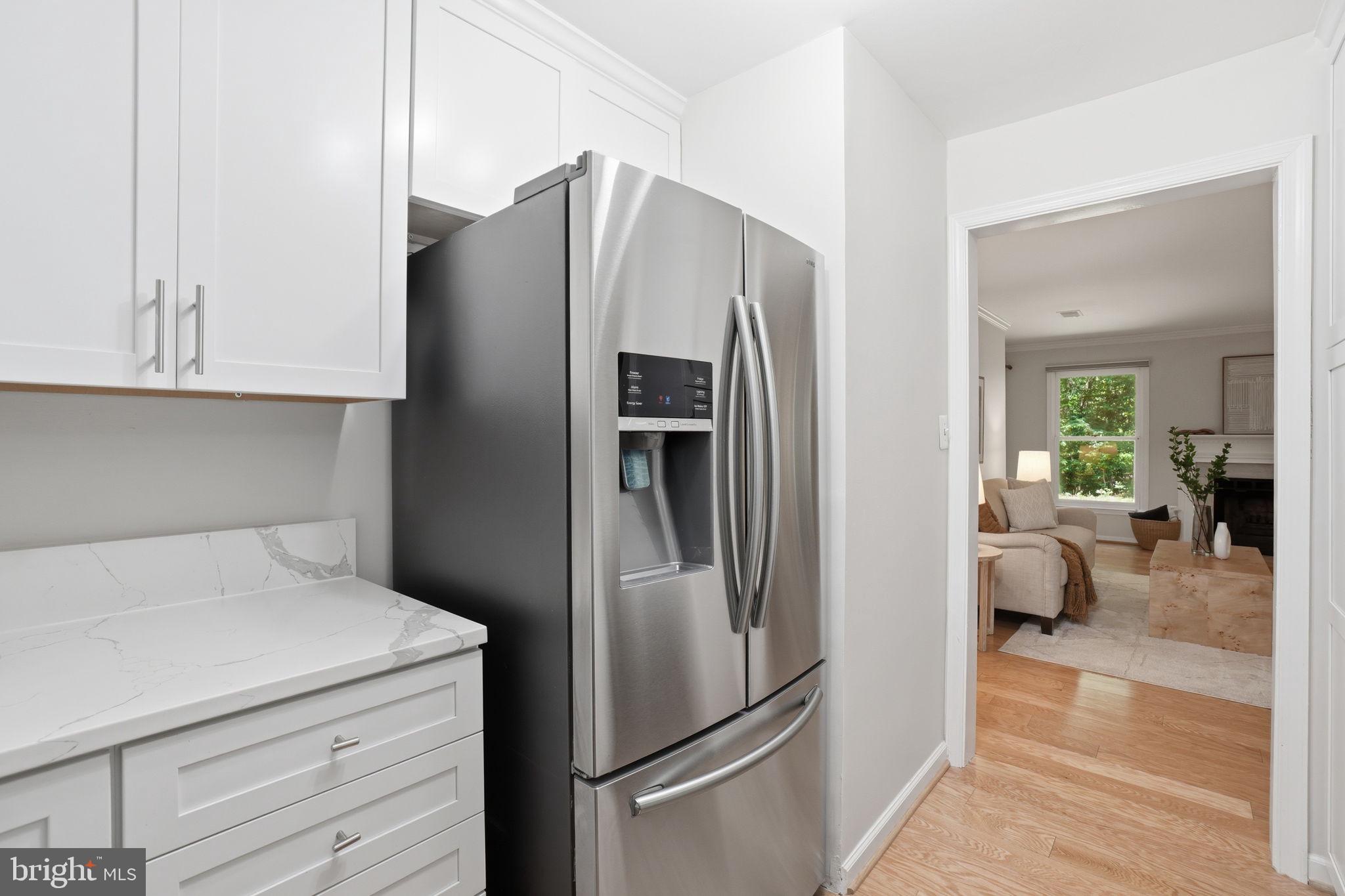 1495 Church Hill Place Reston, VA 20194 - Photo 5 of 27 a kitchen with metallic refrigerator and cabinets