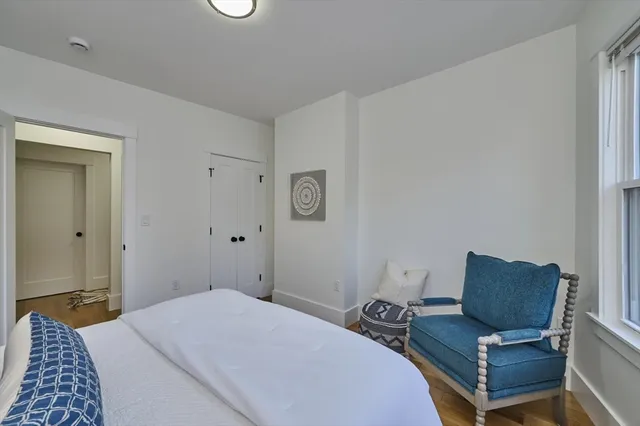 a bedroom with a bed and chair