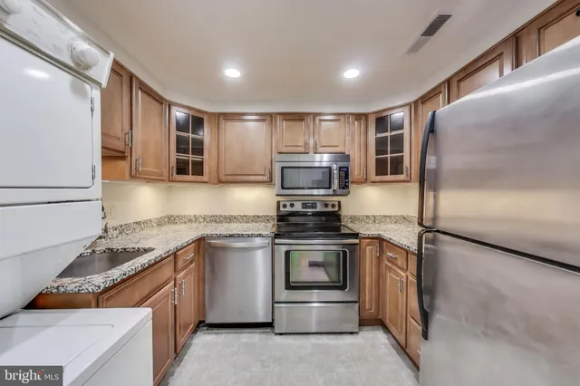 a view of a room with wooden floor and furniture