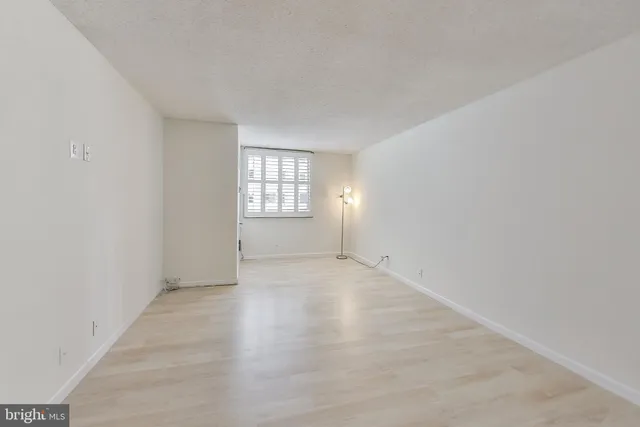 a view of an empty room and wooden floor