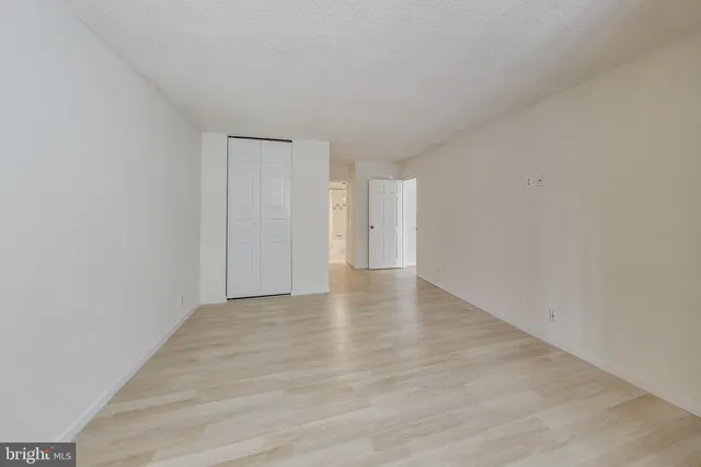 a view of walk in closet with empty racks