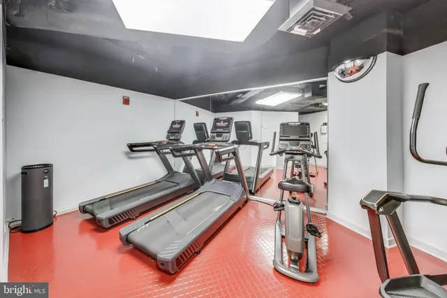 a spacious bathroom with a sink a mirror and a large mirror