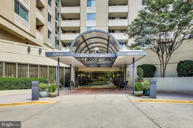 a living room with a large window and a chandelier