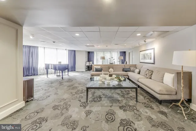 a room with furniture a rug and a window