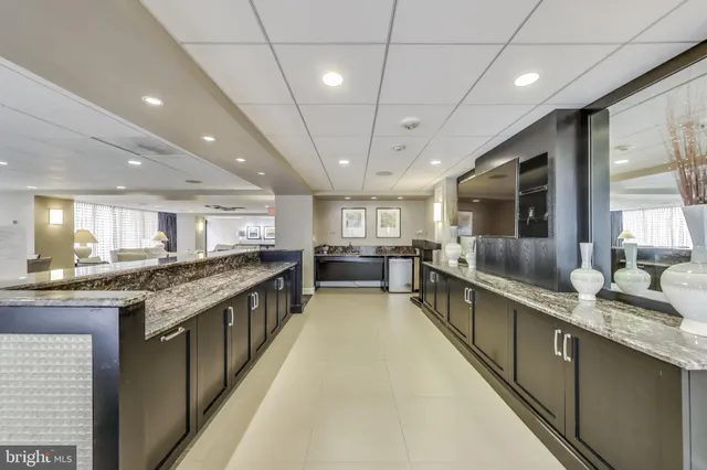 a living room with furniture and a dining table with wooden floor