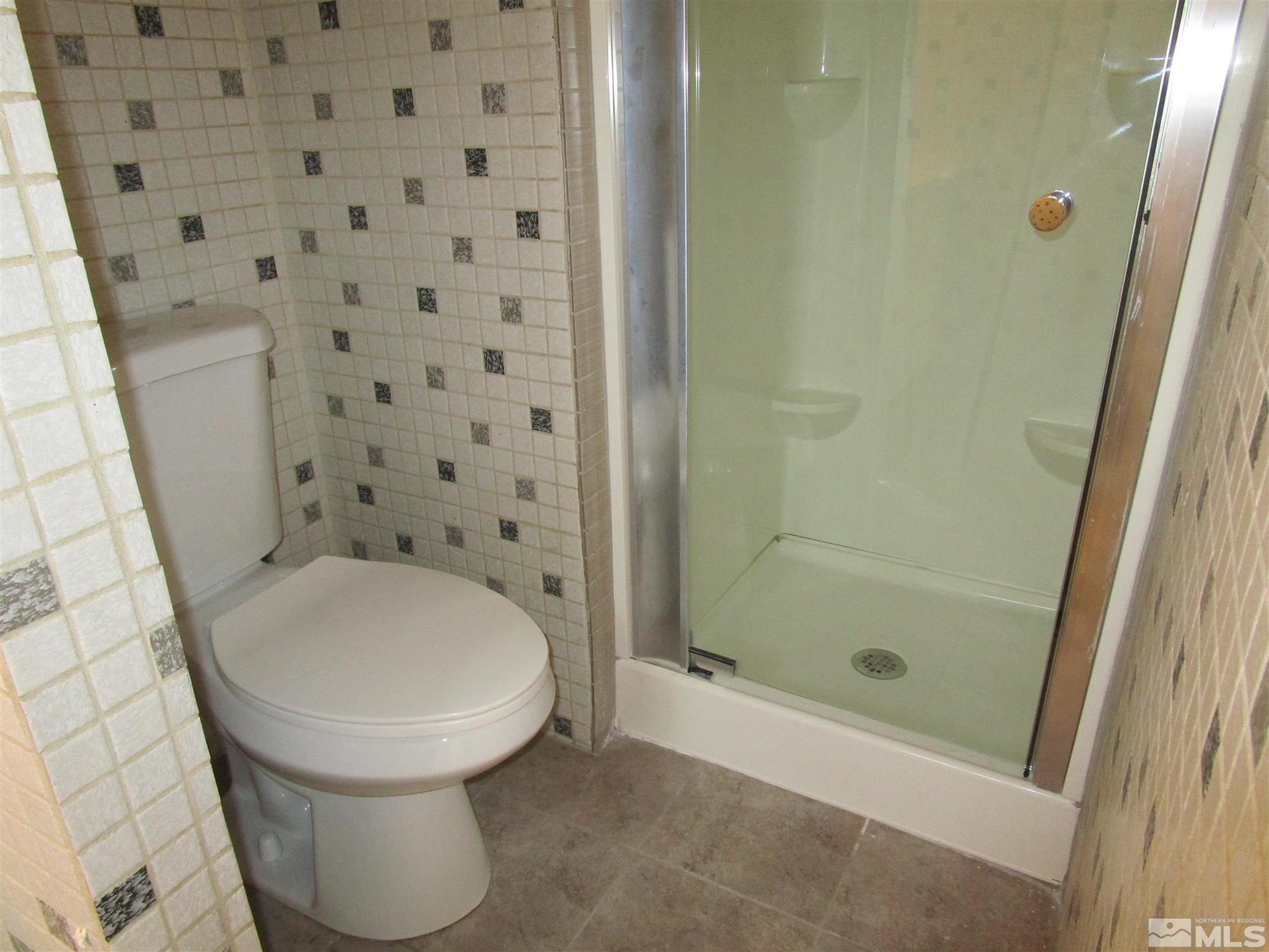 15025 Vega Street Reno, NV 89521 - Photo 12 of 24 a bathroom with a toilet and a shower