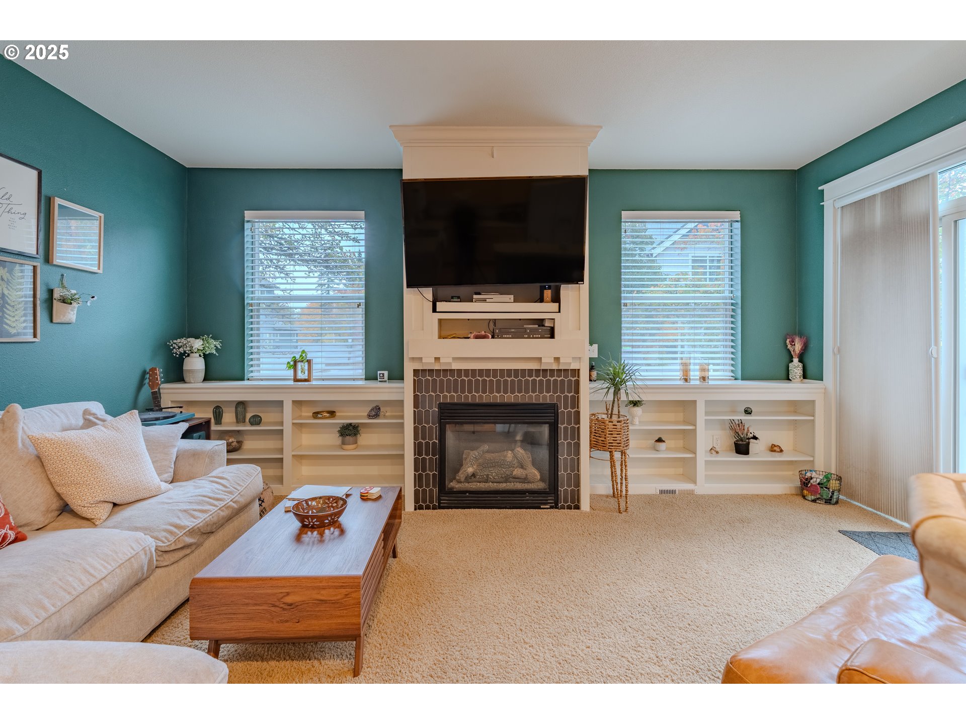 3505 Southeast 197th Avenue Camas, WA 98607 - Photo 13 of 30 a living room with furniture a flat screen tv and a fireplace