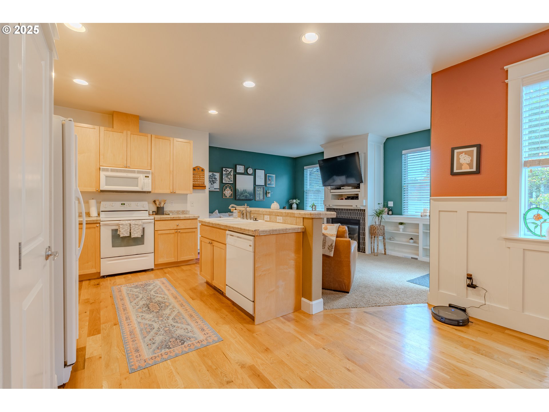 3505 Southeast 197th Avenue Camas, WA 98607 - Photo 9 of 30 a kitchen with stainless steel appliances granite countertop a stove top oven a sink dishwasher and a refrigerator with wooden floor