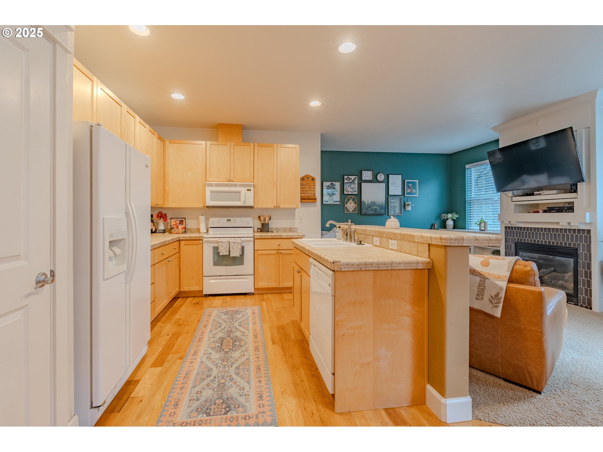 3505 Southeast 197th Avenue Camas, WA 98607 - Photo 10 of 30 a kitchen with stainless steel appliances kitchen island granite countertop a refrigerator a stove top oven a sink and dishwasher