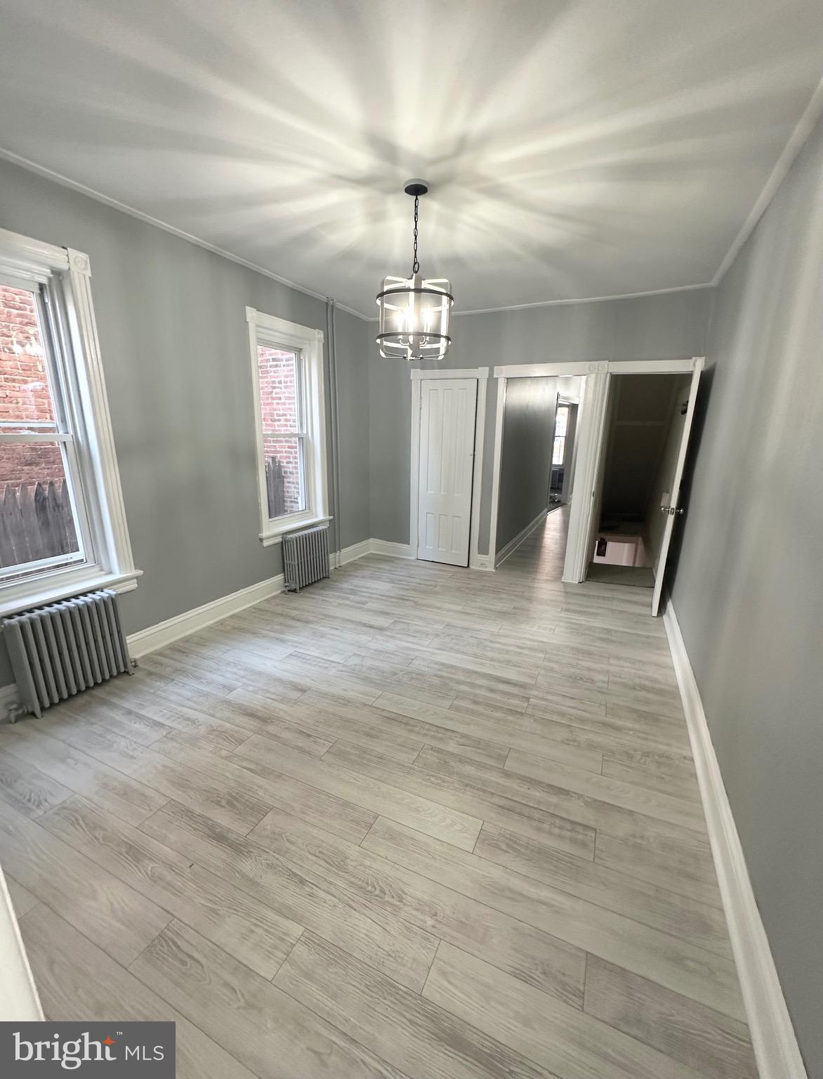 331 Tyler Street Trenton, NJ 08609 - Photo 12 of 49 wooden floor in an empty room with a window