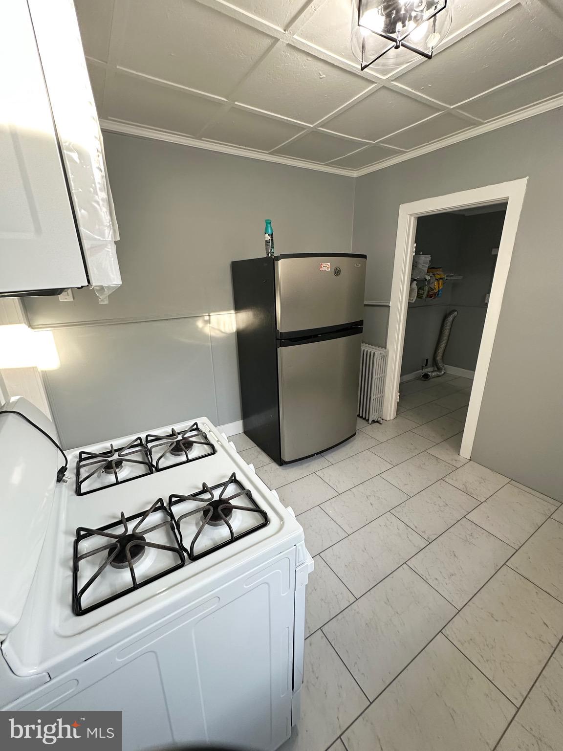 331 Tyler Street Trenton, NJ 08609 - Photo 17 of 49 a kitchen with a stove and a refrigerator