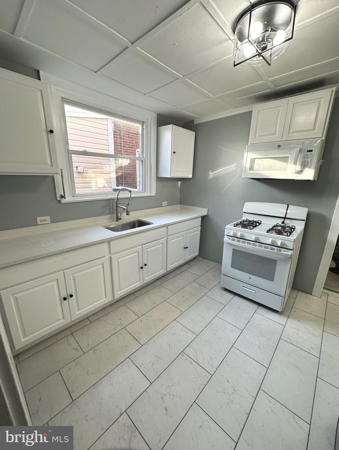 331 Tyler Street Trenton, NJ 08609 - Photo 19 of 49 a kitchen with cabinets and window
