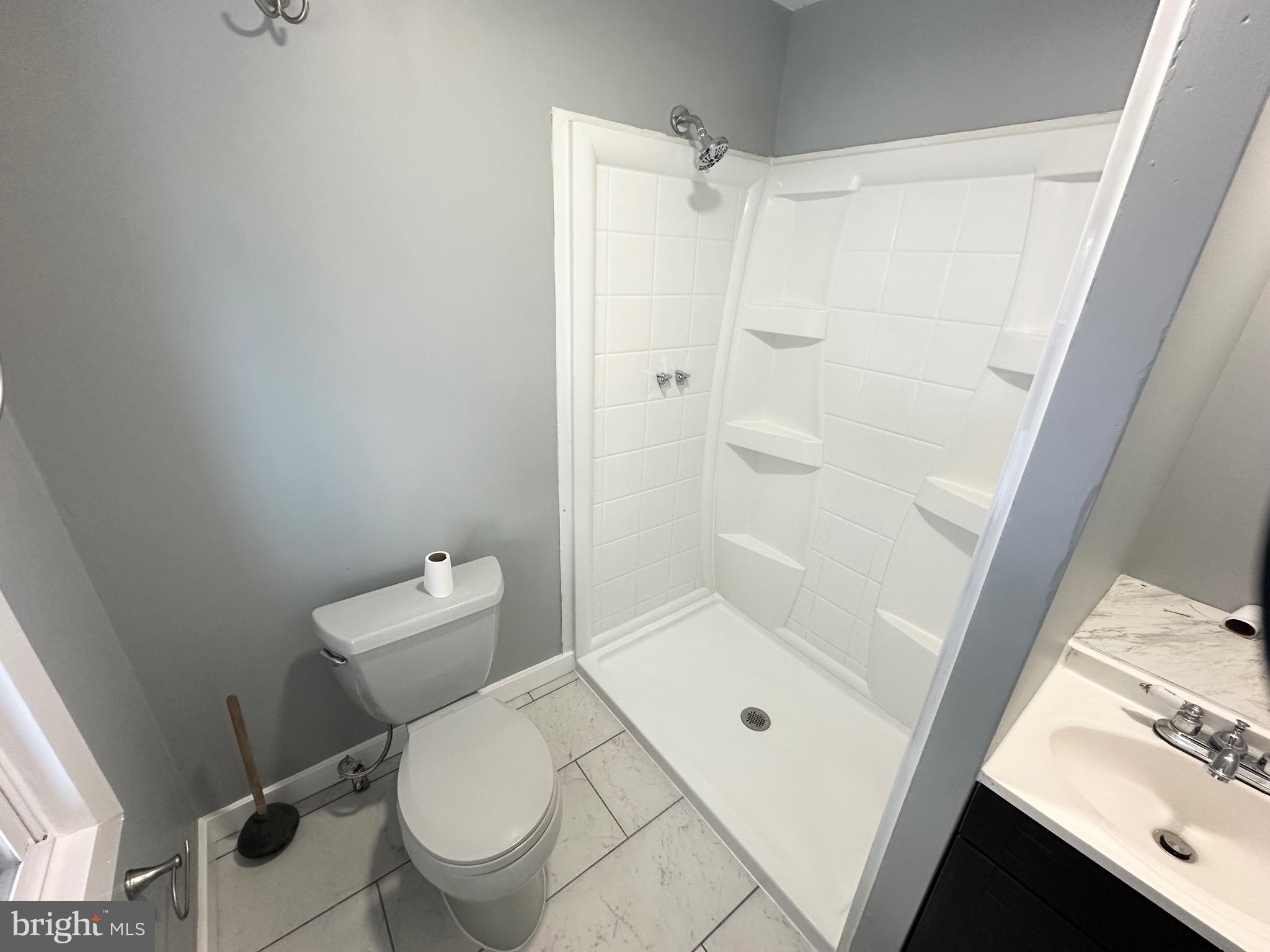 331 Tyler Street Trenton, NJ 08609 - Photo 21 of 49 a white toilet sitting next to a bathroom sink