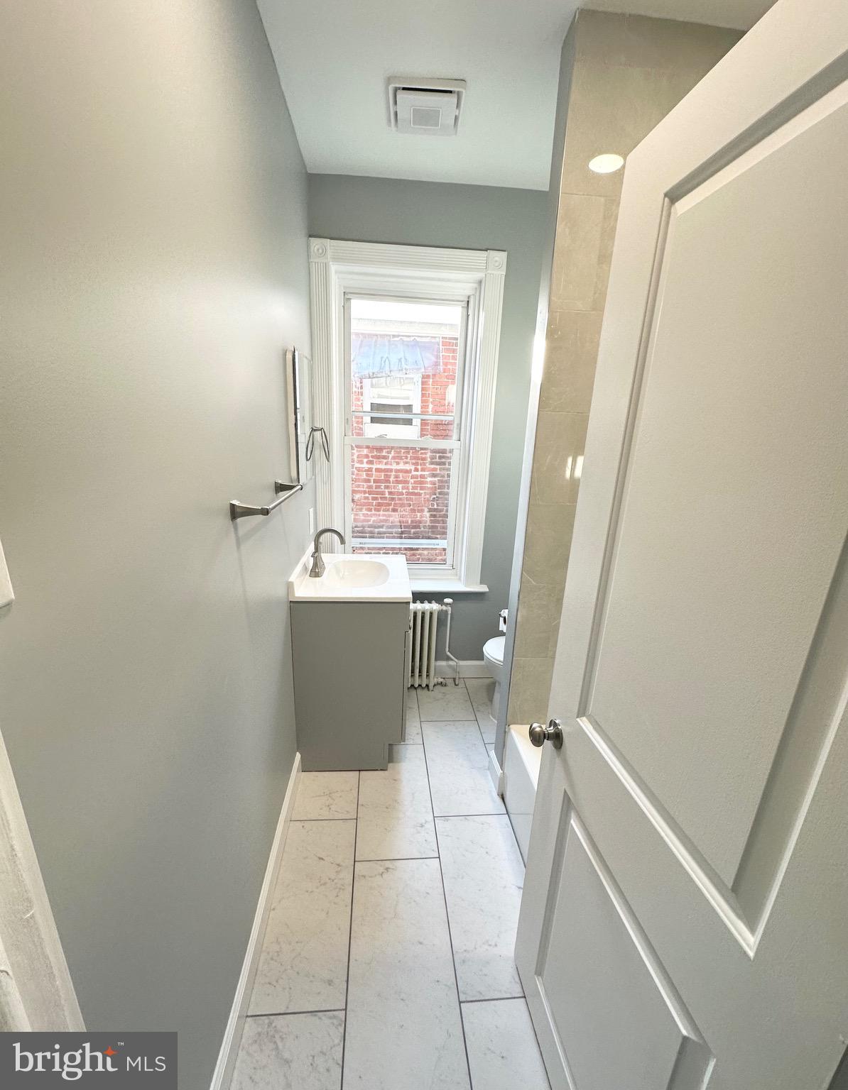331 Tyler Street Trenton, NJ 08609 - Photo 27 of 49 a bathroom with a sink a toilet and a mirror