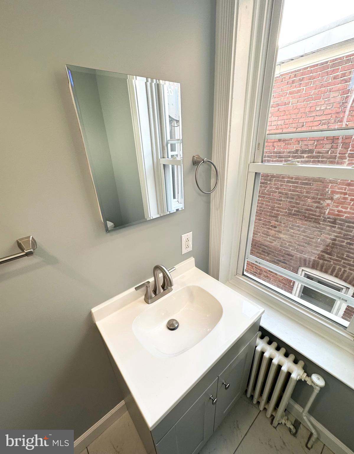 331 Tyler Street Trenton, NJ 08609 - Photo 29 of 49 a bathroom with a sink and a mirror
