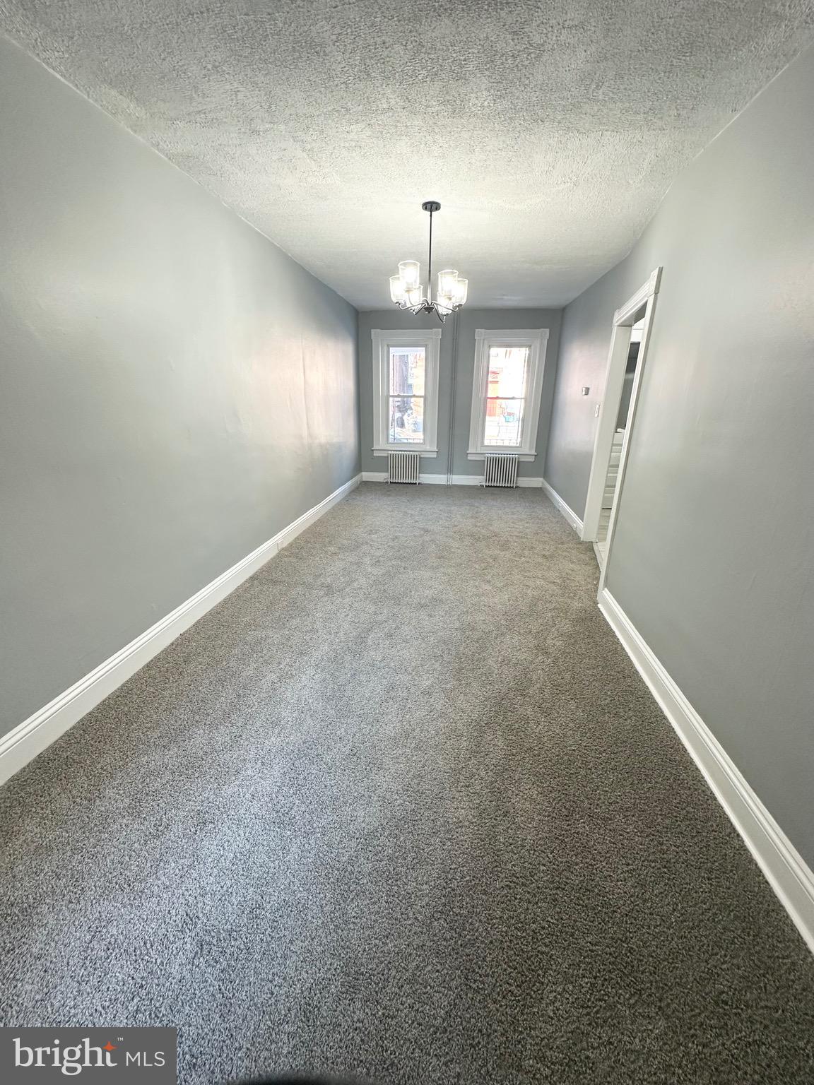331 Tyler Street Trenton, NJ 08609 - Photo 8 of 49 an empty room with stairs and wooden floor